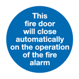 This fire door will close automatically on operation of fire alarm MJN Safety Signs Ltd